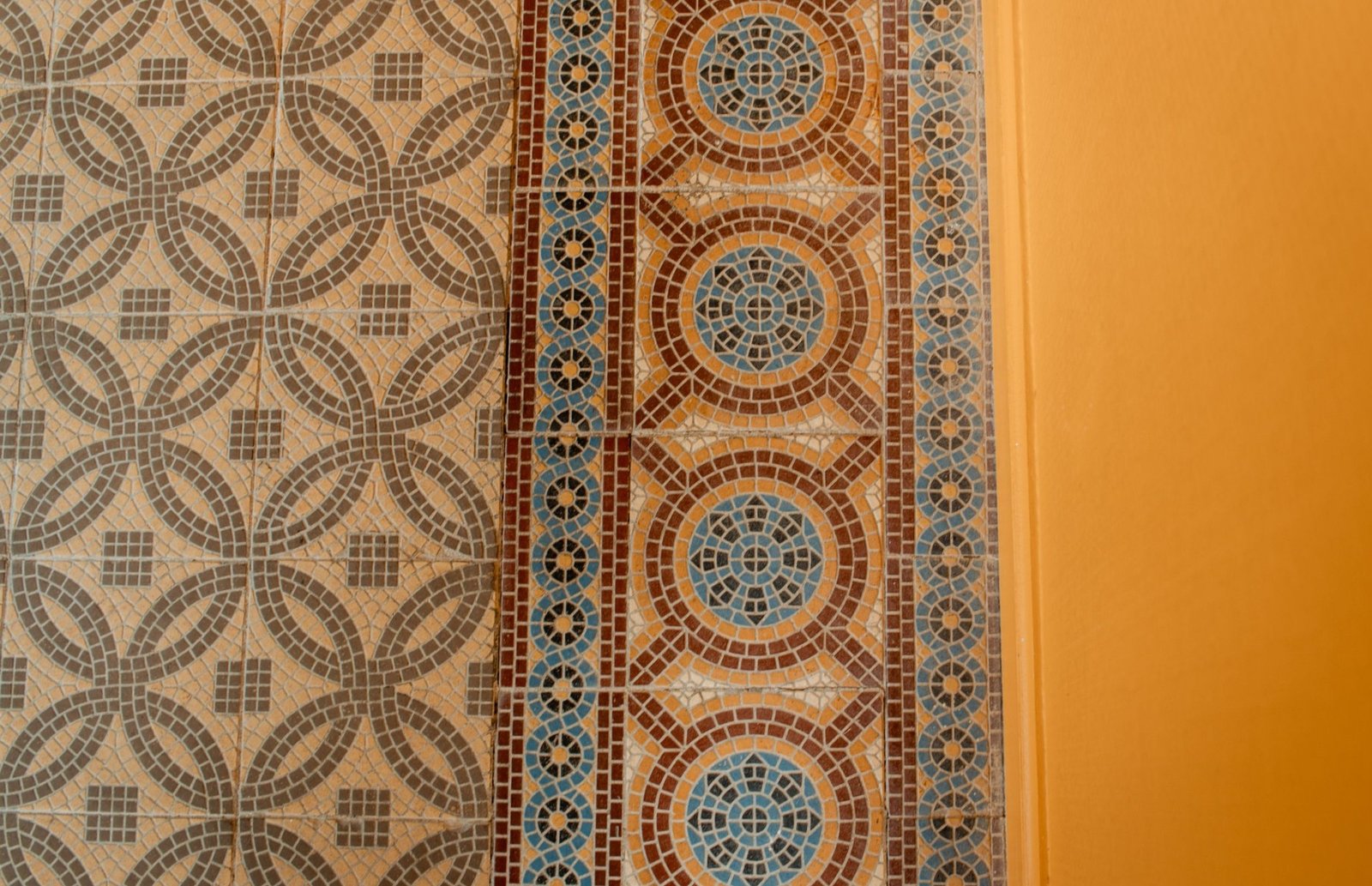 Close-up of decorative mosaic tiles in cream, brown and muted blue tones